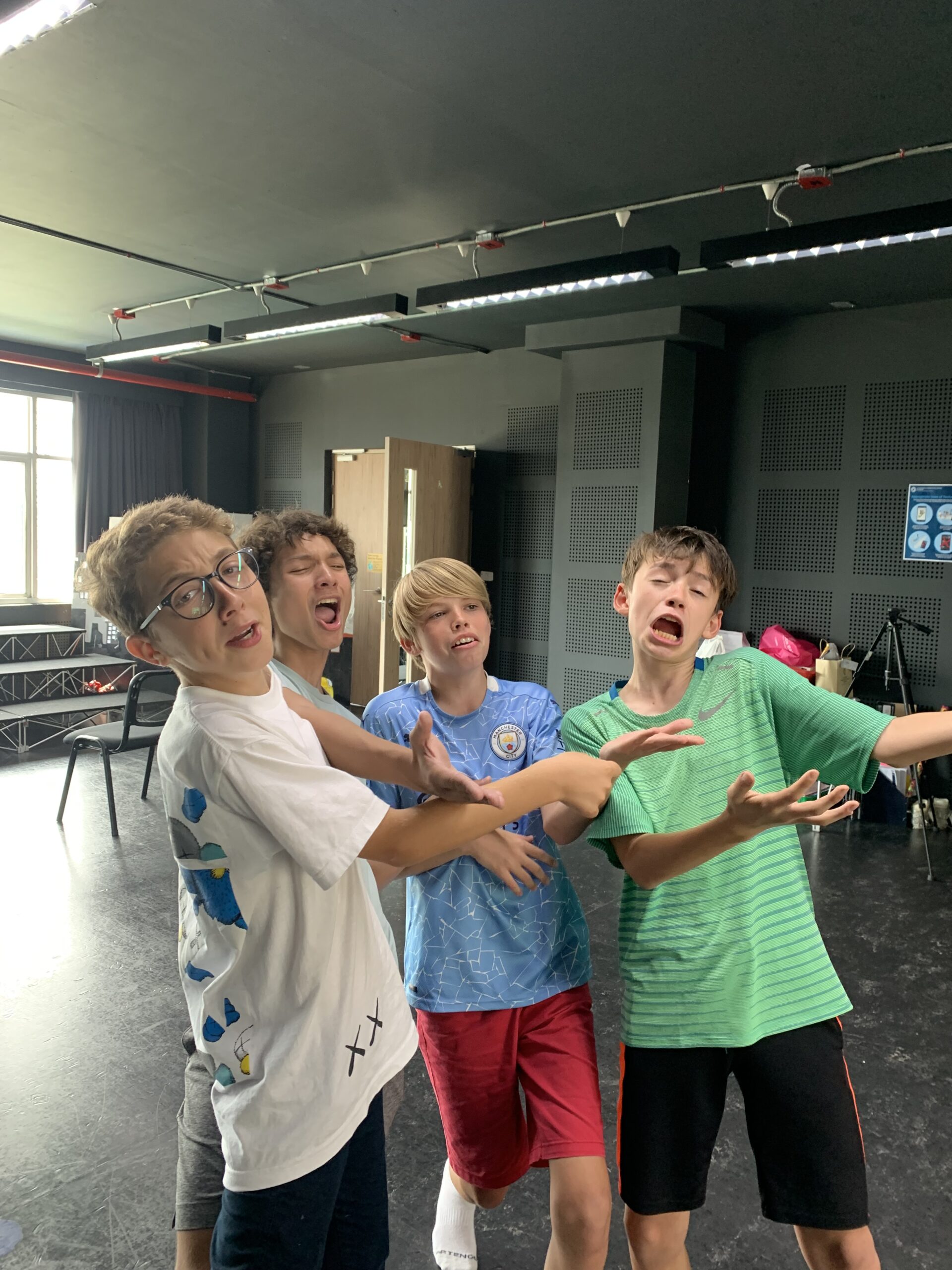 Four young performing arts students having a blast in an improv lesson.